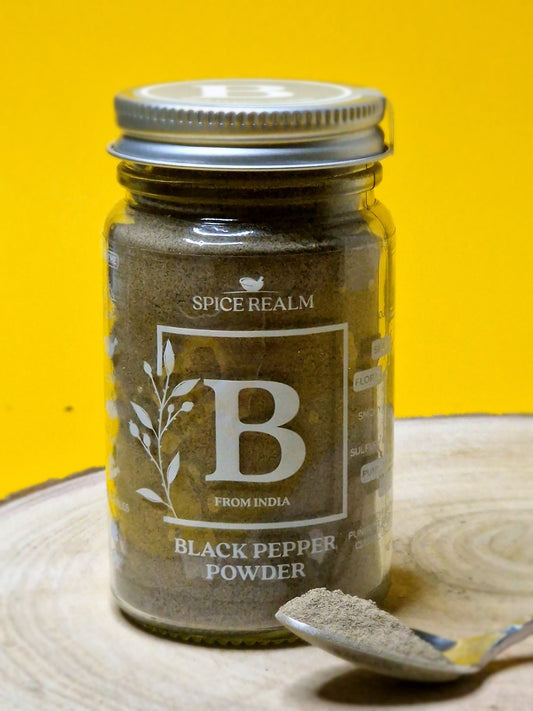 Jar of organic Black Pepper Powder, exhibiting its dark grey colour and fine, speckled texture.