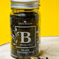 Jar of whole organic Black Peppercorns, showcasing their round shape and dark, wrinkled appearance.