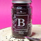 Jar of organic Brown Mustard Seeds, displaying their small, round shape and rich brown colour