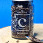 Jar of organic Cacao Nibs, showcasing their dark brown colour and crunchy, irregular shapes