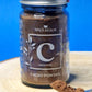 Jar of organic Cacao Powder, displaying its rich, dark brown colour and fine texture