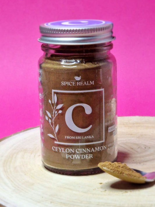 Jar of organic Ceylon Cinnamon Powder, exhibiting its light brown colour and fine, sandy texture