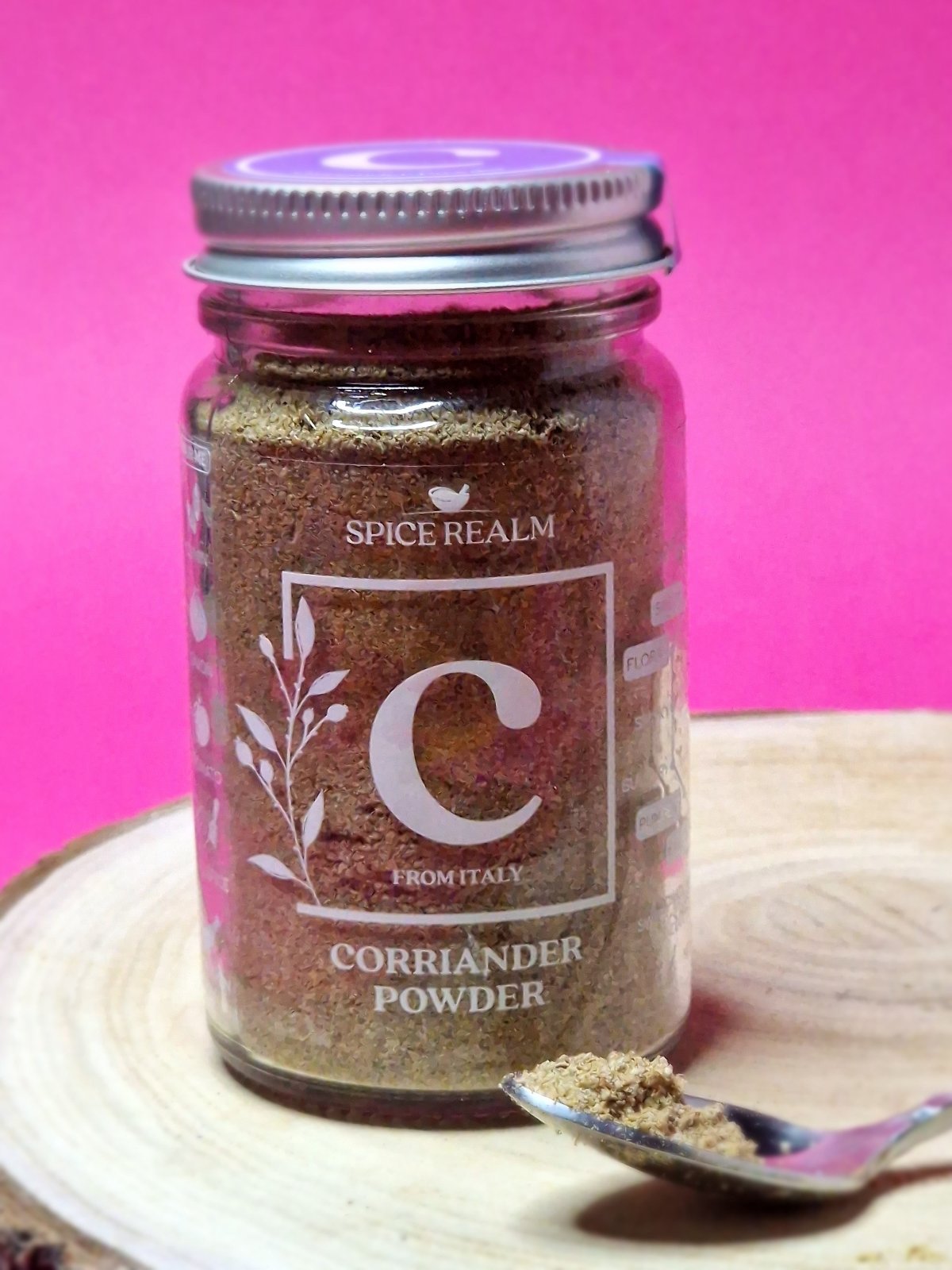 Jar of organic Coriander Powder, exhibiting its light beige colour and fine, sandy texture