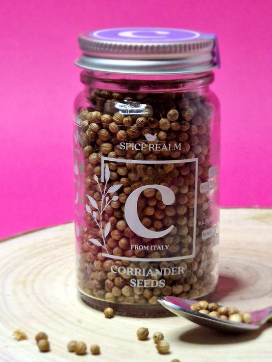 Jar of organic Coriander Seeds, displaying their small, round shape and light brown colour