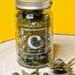 Jar of dried organic Curry Leaves, showing their small, oval shape and deep green colour