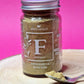 Jar of organic Fenugreek Powder, exhibiting its yellowish-brown colour and fine, powdery texture