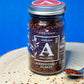 Close-up image of vibrant red Aleppo chilli flakes, showcasing their coarse texture and deep red hue, perfect for adding a mild heat and fruity flavour to a variety of dishes