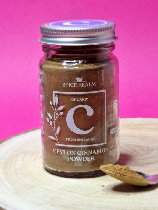 Jar of organic Ceylon Cinnamon Powder, exhibiting its light brown colour and fine, sandy texture