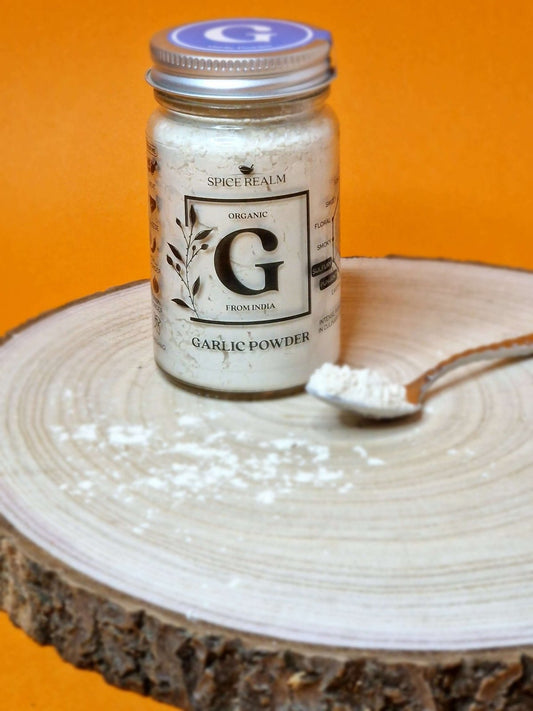 Jar of organic Garlic Powder, displaying its off-white colour and fine, granular texture