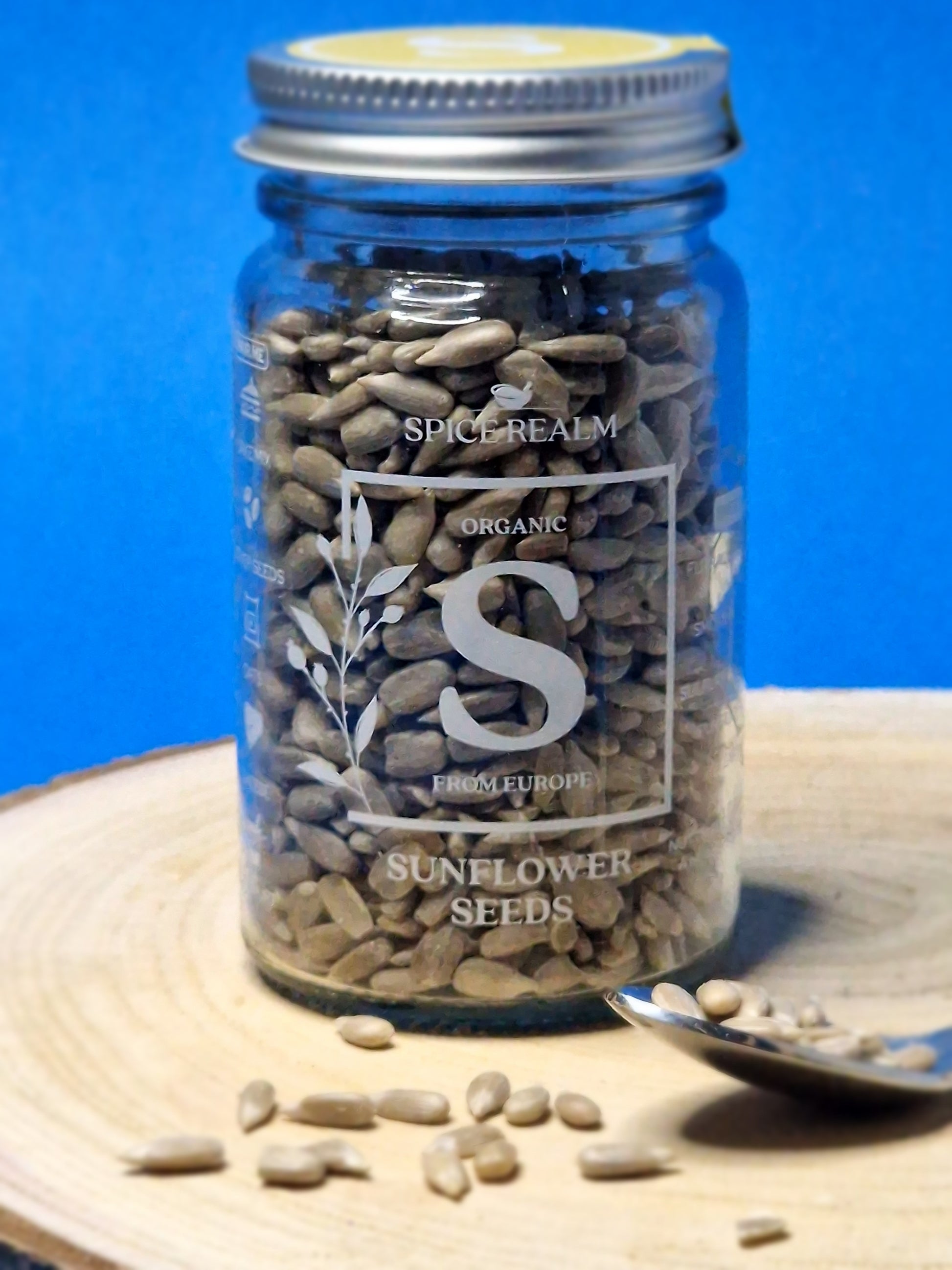 Jar of organic Sunflower Seeds, showcasing their flat, oval shape and light grey-green colour